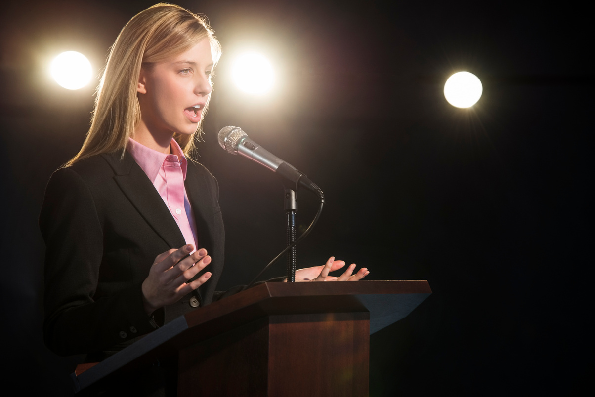 Businesswoman Giving a Speech on a Podium 